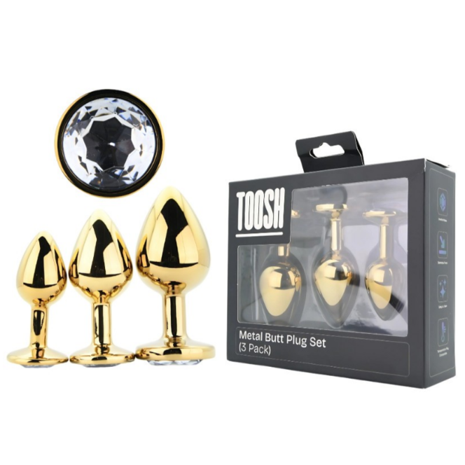 Gold metal butt plug set with packaging labeled 'TOOSH' on a white background.