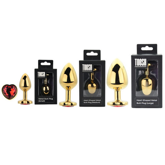 Gold butt plugs with packaging labeled 'TOOSH' on a white background