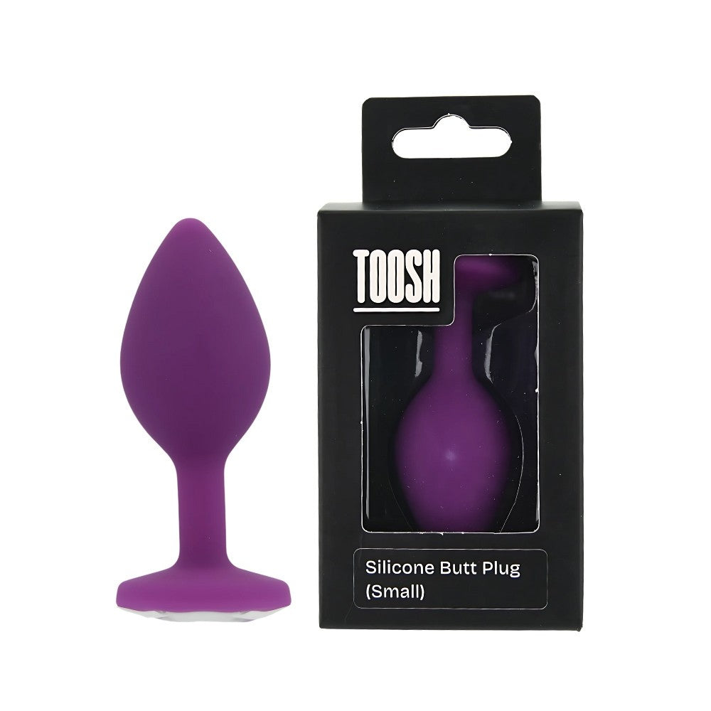 Purple silicone butt plug with packaging on a white background