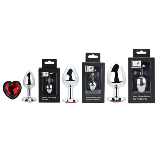 Collection of metal butt plugs with packaging labeled 'Toosh' on a white background.