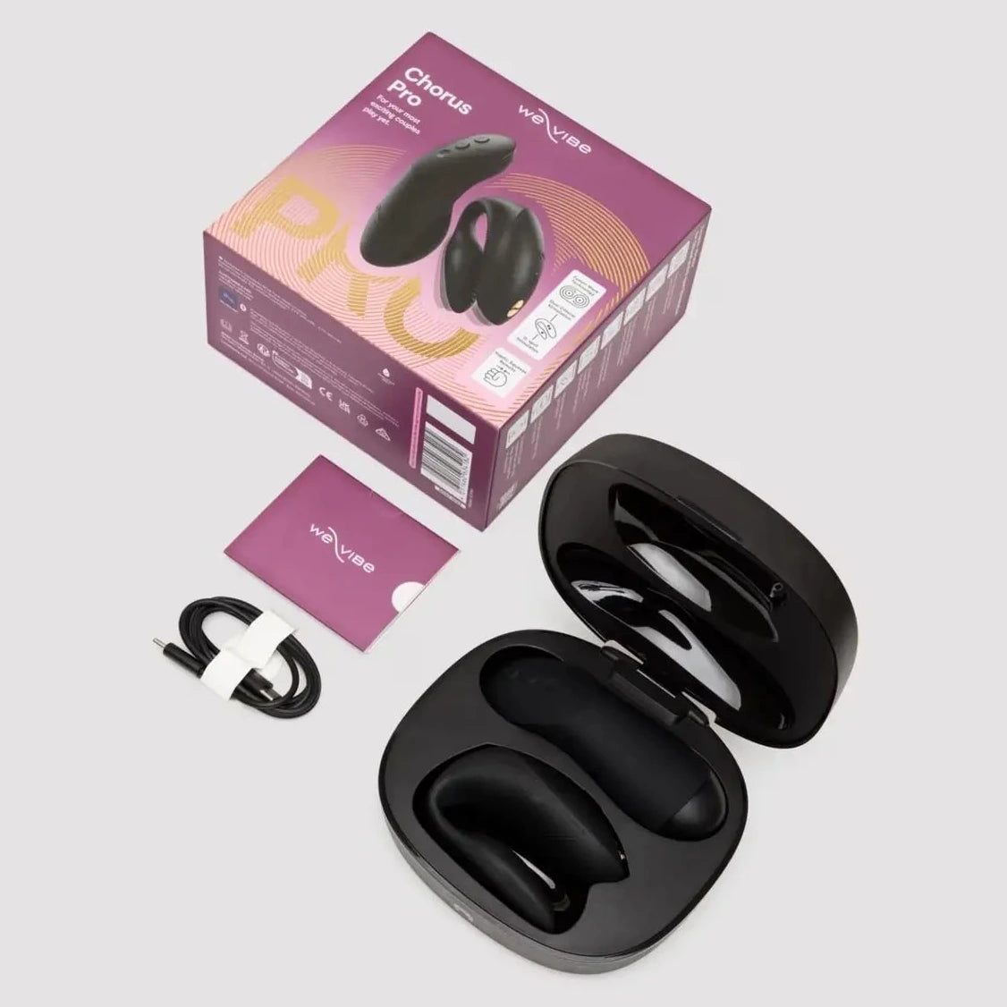 Black wireless couples vibrator with charging case and packaging on a light gray background