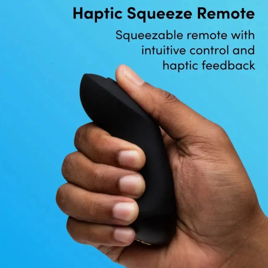 Hand holding a haptic squeeze remote with text on a blue background