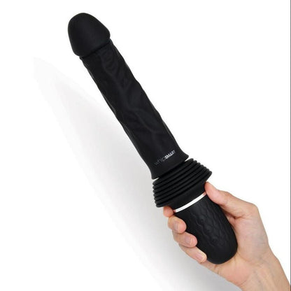 Black cylindrical dildo held by a hand on a white background