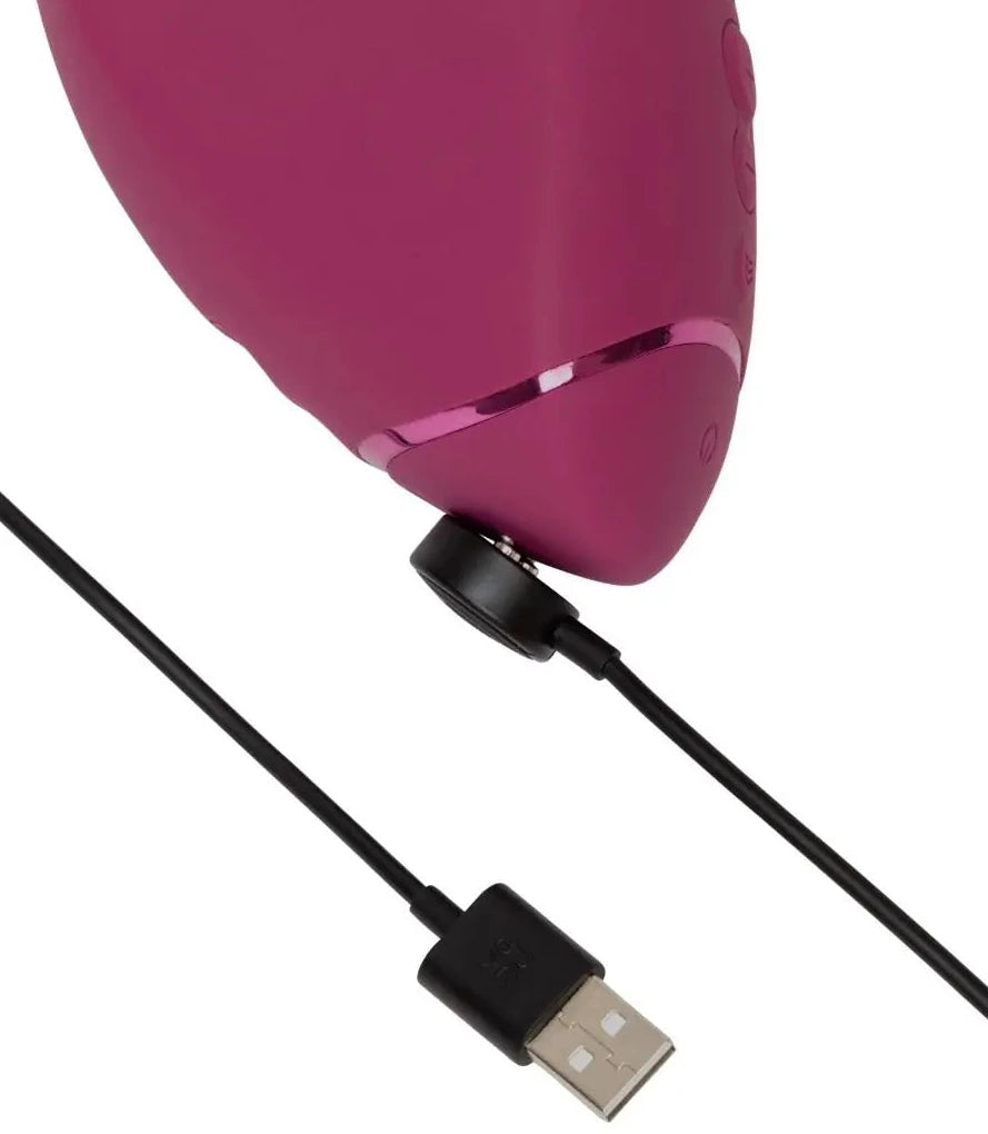 Pink massager with USB cable on a white background