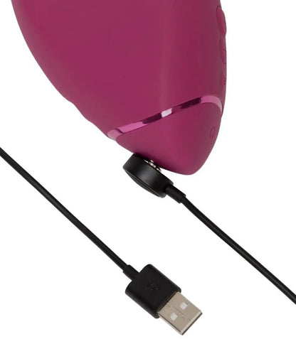 Pink massager with USB cable on a white background