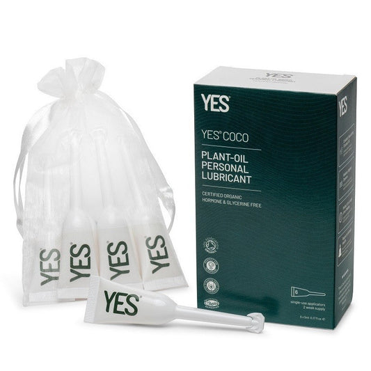 YES Coco plant-oil personal lubricant packaging with a box, bags, and a applicator on a white background.