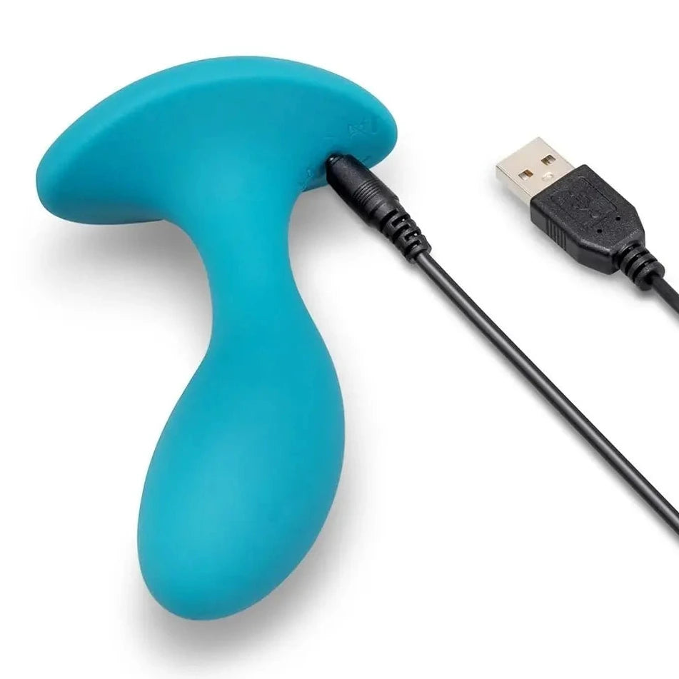 Turquoise handheld massage device with USB cable on a white background