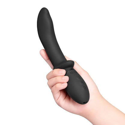 Black handheld electronic prostate massage device held in a hand against a white background
