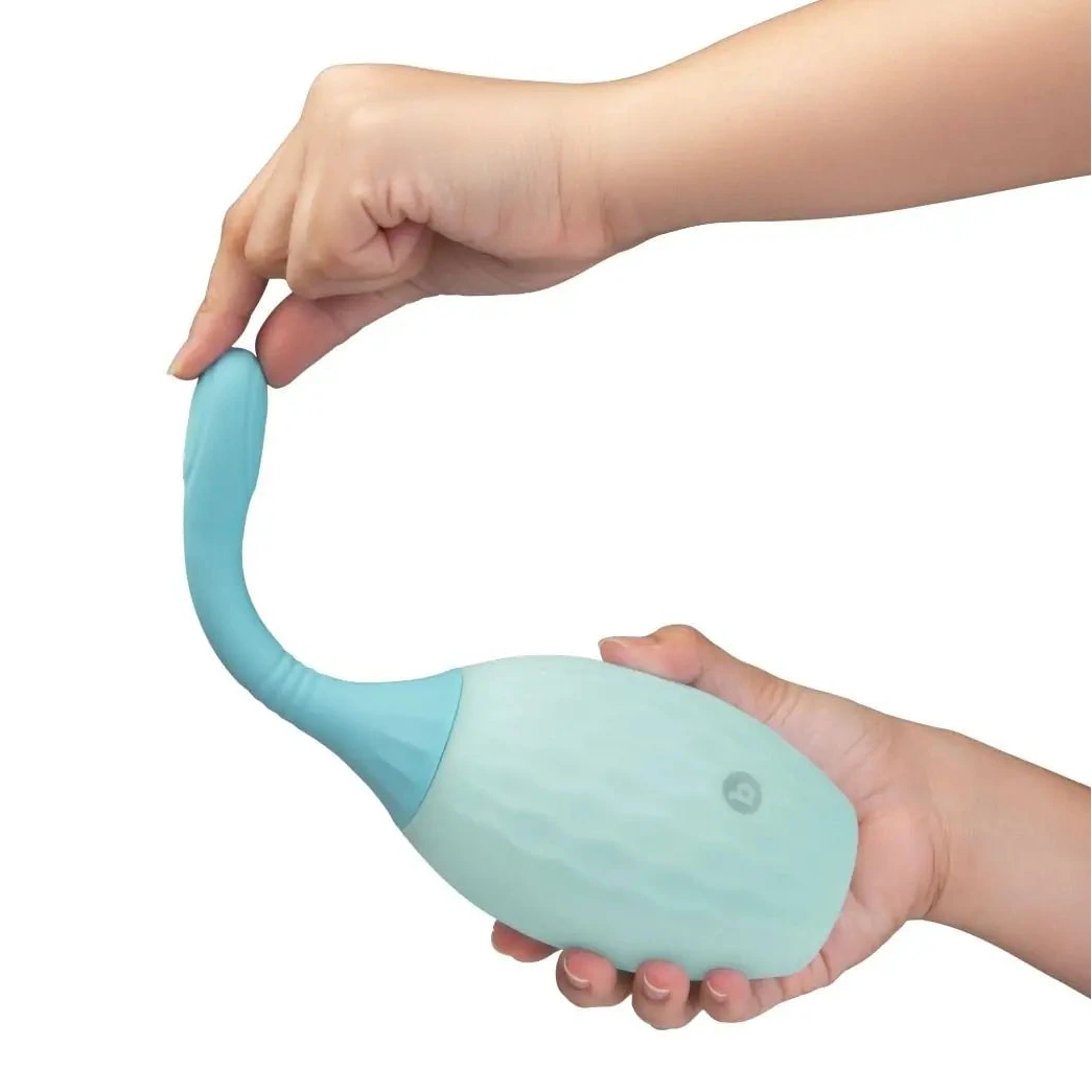 Light blue silicone anal enema douche held by a hand on a white background