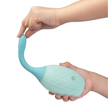 Light blue silicone anal enema douche held by a hand on a white background