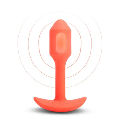 Orange silicone butt plug on a white background
