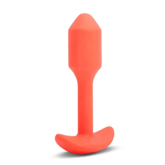 Orange silicone butt plug on a white background