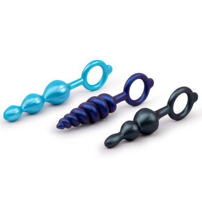 Three colorful anal toys on a white background