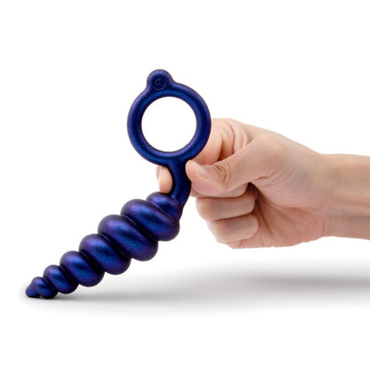 Hand holding a blue anal toy with a white background