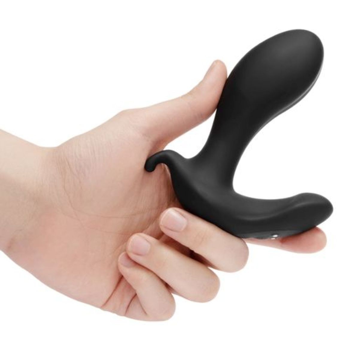 Black silicone butt plug being held in a hand on a white background