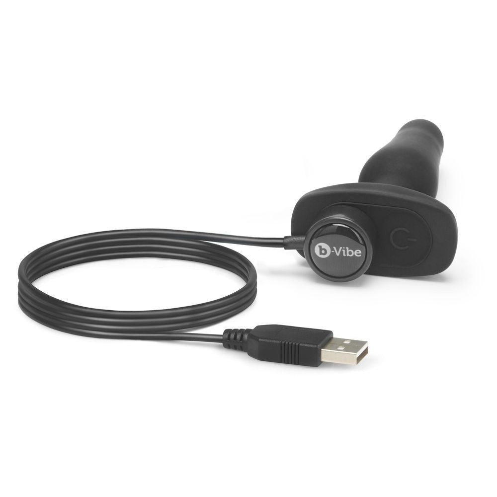Black electronic device with USB cable on a white background