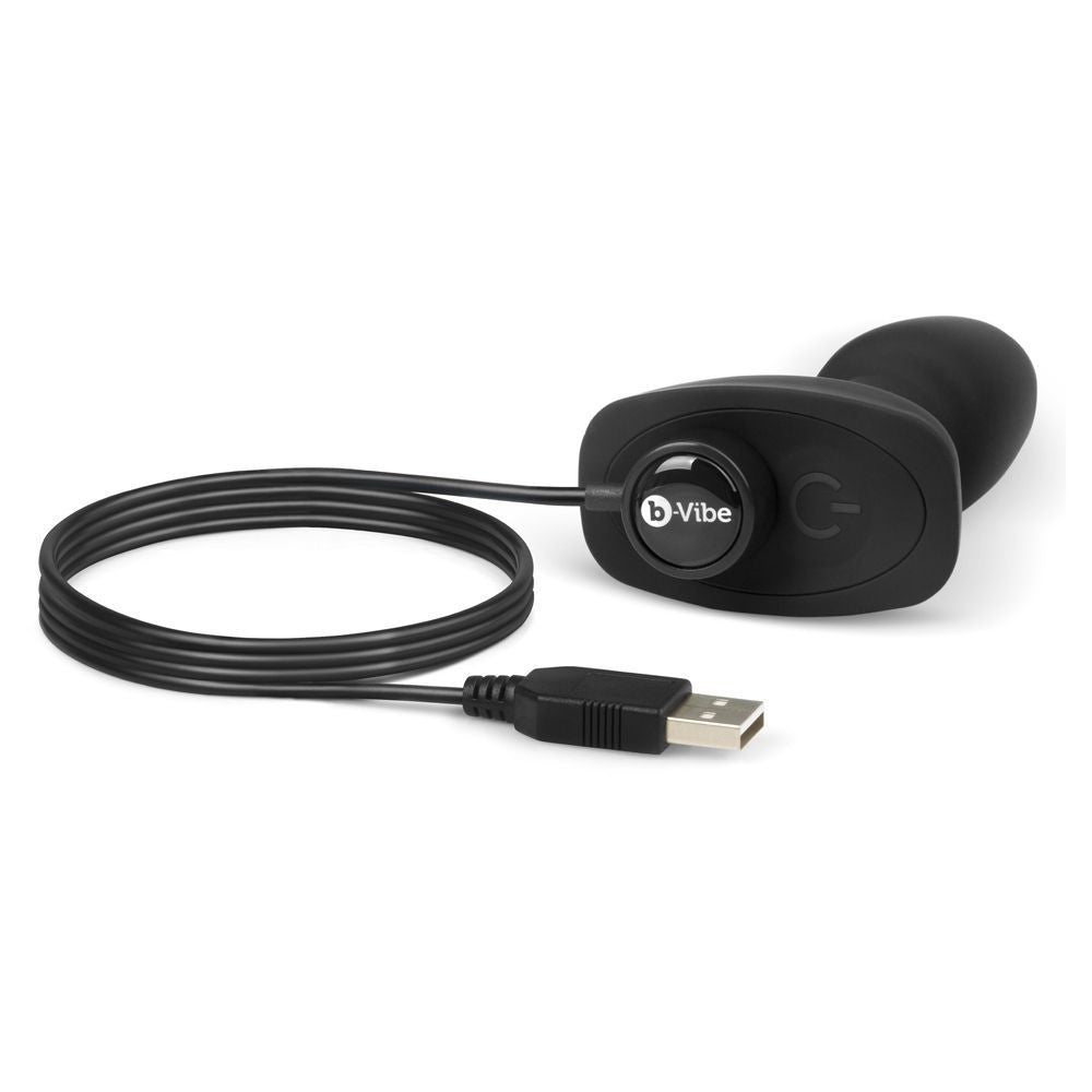 Black electronic device with USB cable on a white background