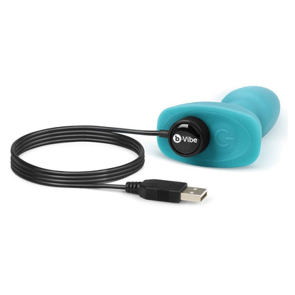 Turquoise silicone device with USB cable on a white background