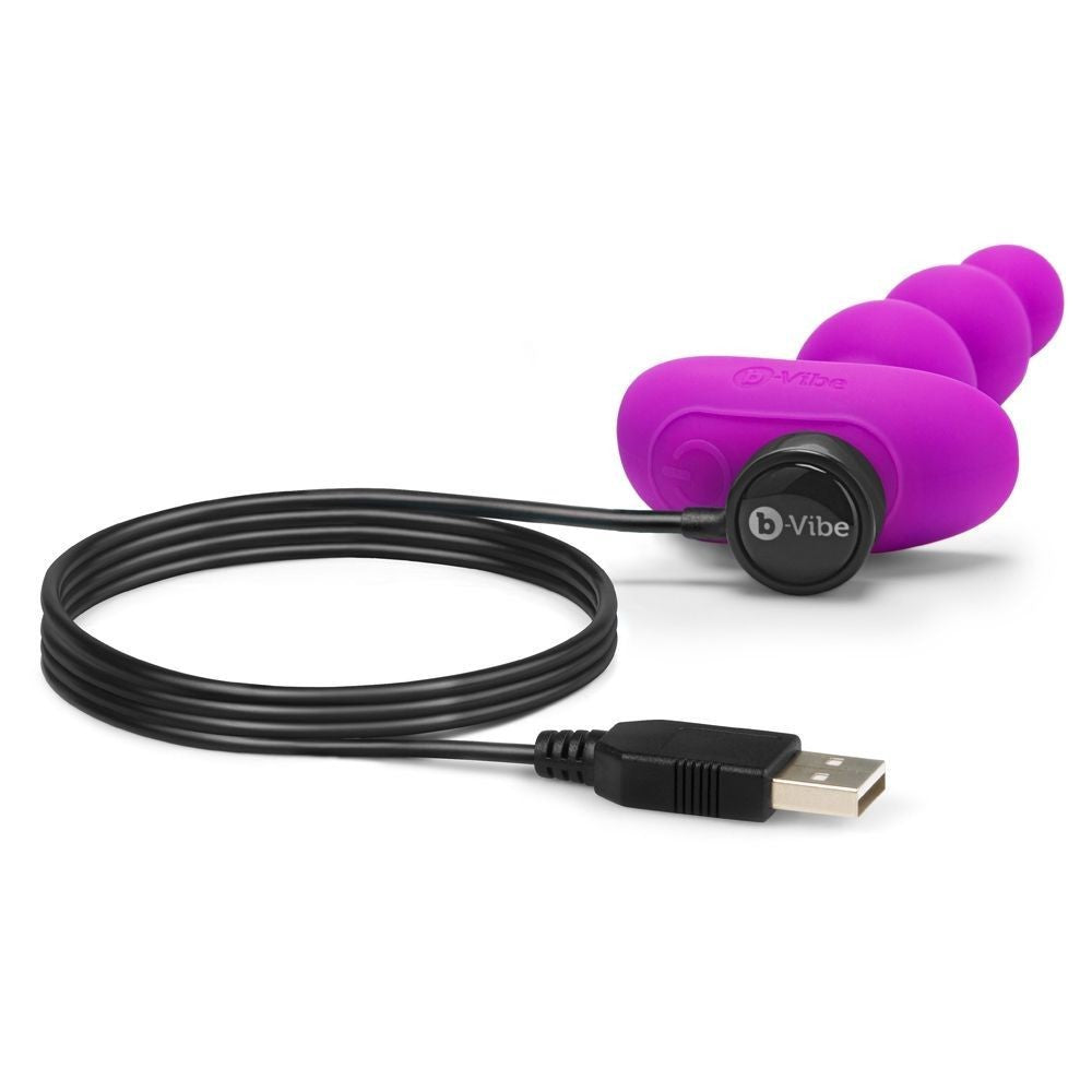 Purple electronic device with USB cable on a white background