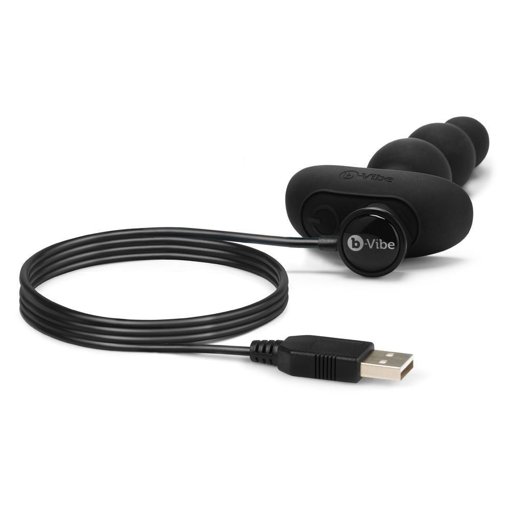 Black electronic device with USB cable on a white background