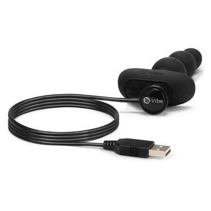 Black electronic device with USB cable on a white background