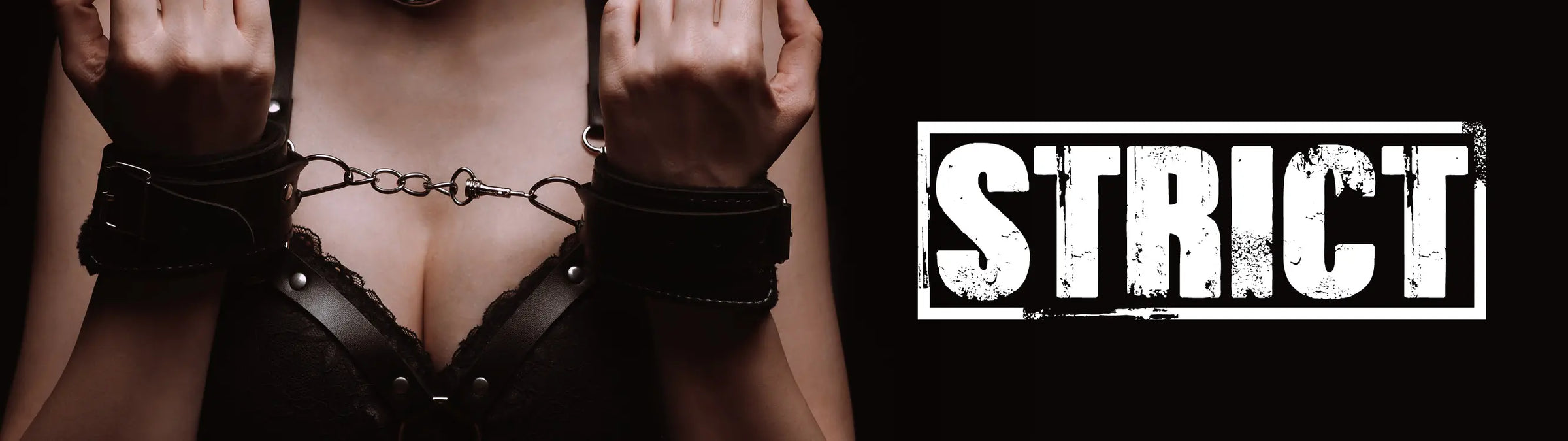 Person wearing a black cuffs with 'Strict' branding on a dark background