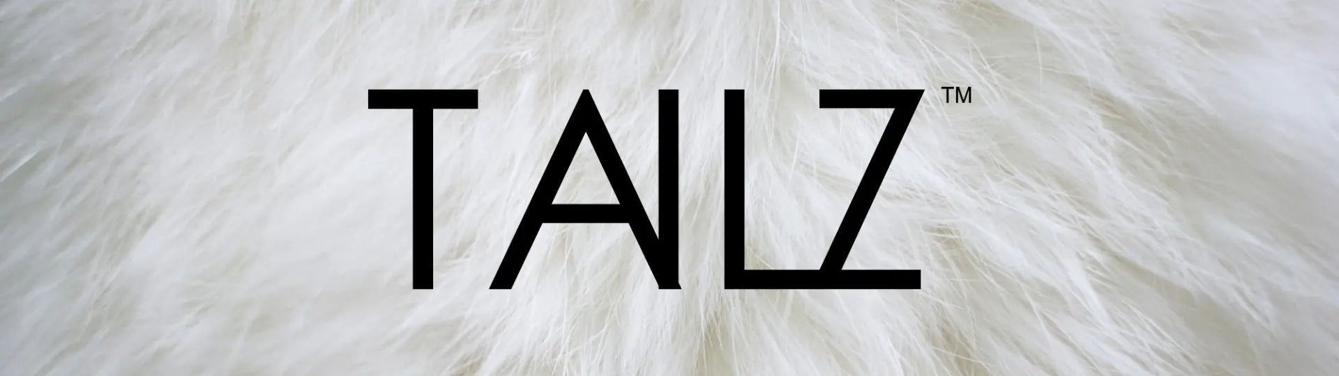 Text 'TAILZ' on a furry white background