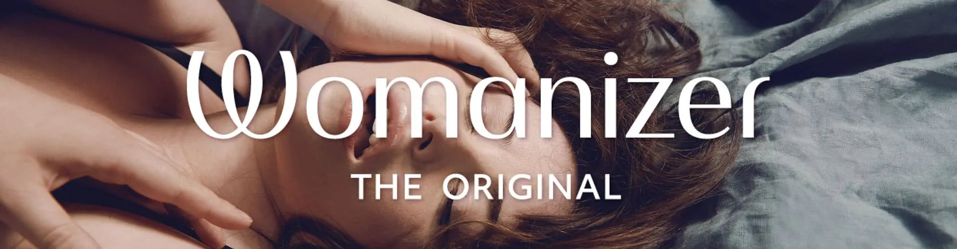 Advertisement for 'Womanizer' with a person lying down, text overlayed.